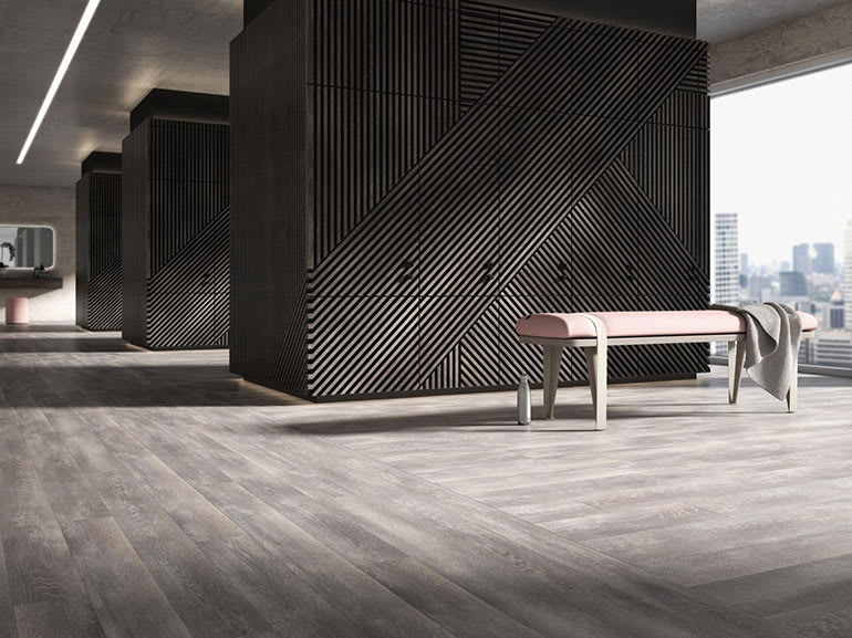 Grey Amtico LVT flooring in a large modern room with large windows