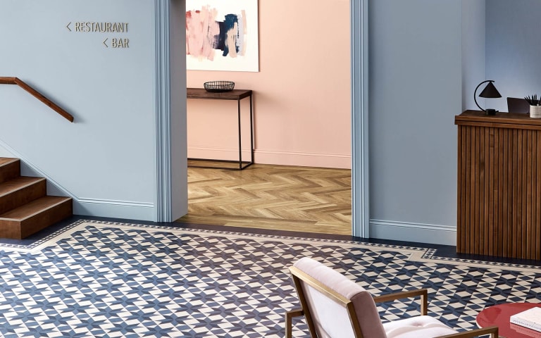 White and blue geometric pattern tiles with dark blue border around the floor