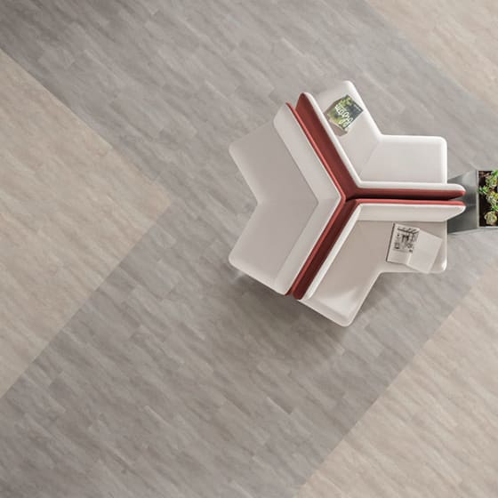 Calming marbled grey floor tiles and marbled neutral pink floor tiles in an angular pattern