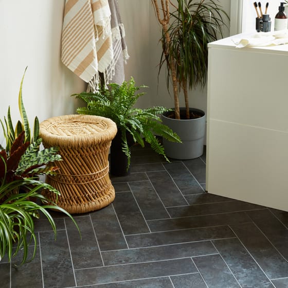 A statement bathroom floor with Black Burnished Metal in Large Parquet with Polished Silver stripping.