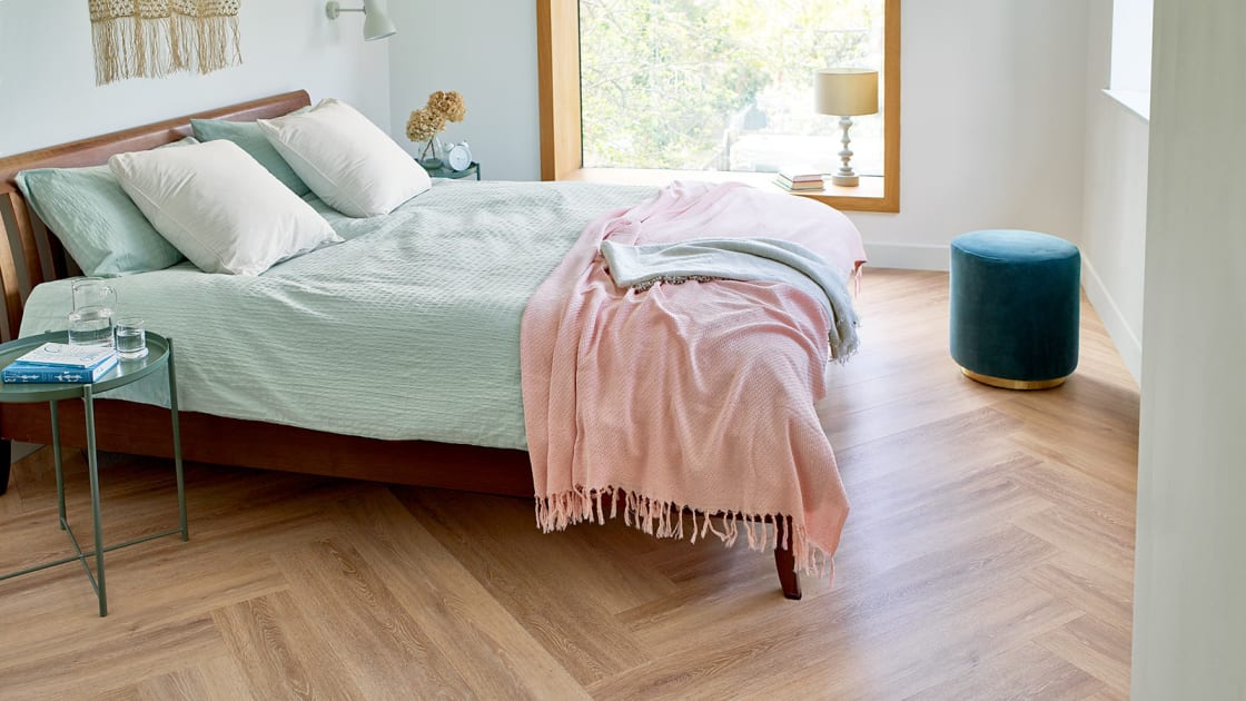 The bedroom floor features Muted Oak in a Herringbone Plank Laying Pattern.